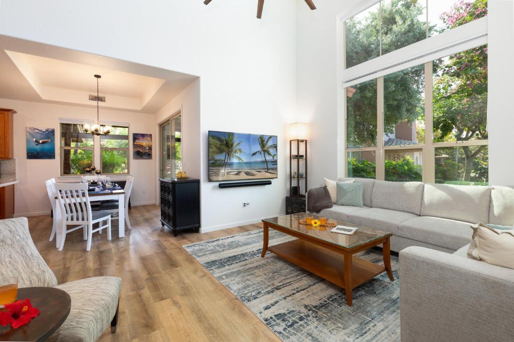 a living room with a couch and a table at ❤PiH❤ Hono Loa BikesBeach Toys Private Beach Club in Waikoloa