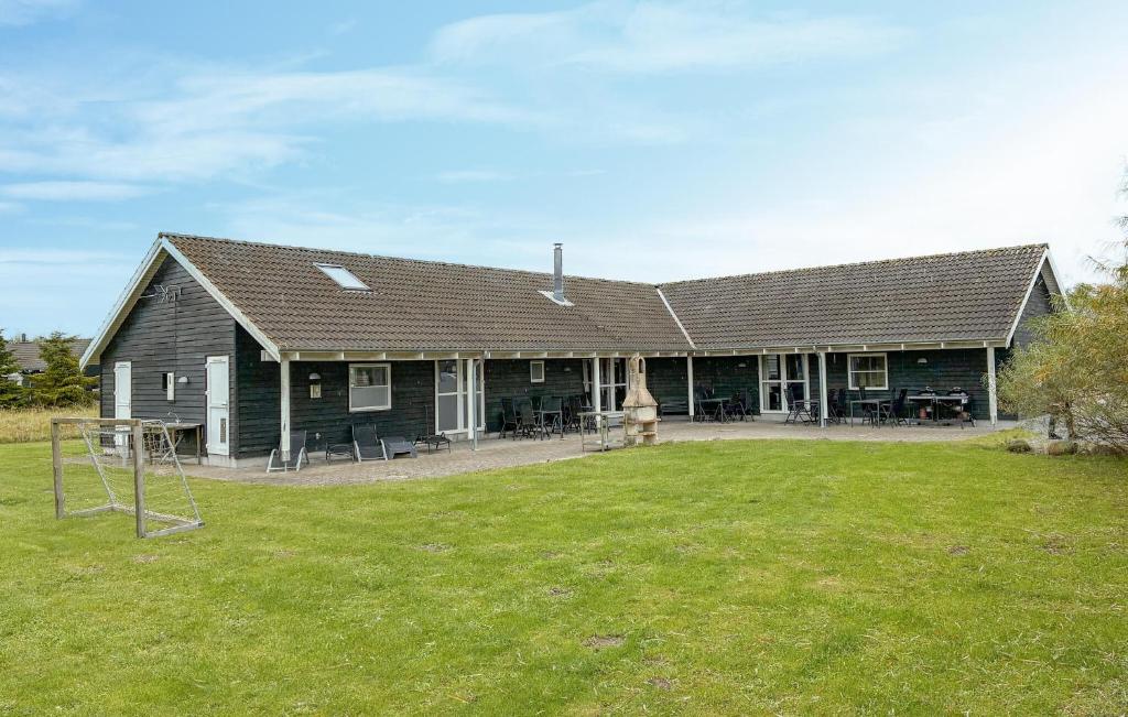 a large house with a yard in front of it at Amazing Home In Væggerløse With Sauna in Marielyst
