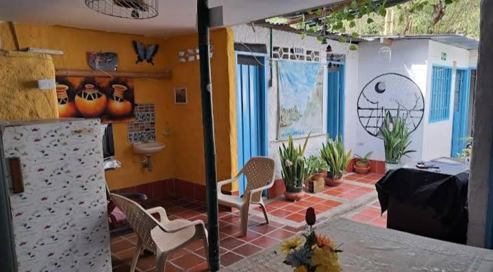 a room with a table and chairs and plants at Hostal Rolled in Villavieja