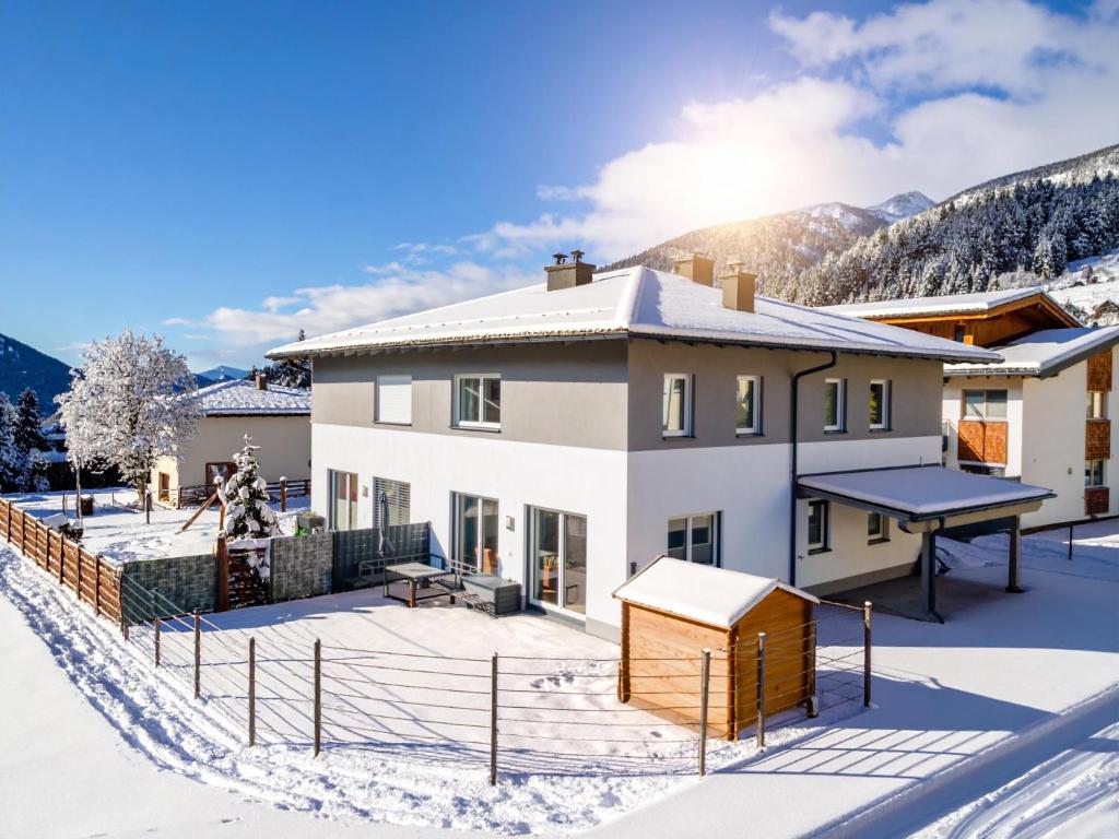 a house in the snow with a ping pong table at JooP in Niedernsill
