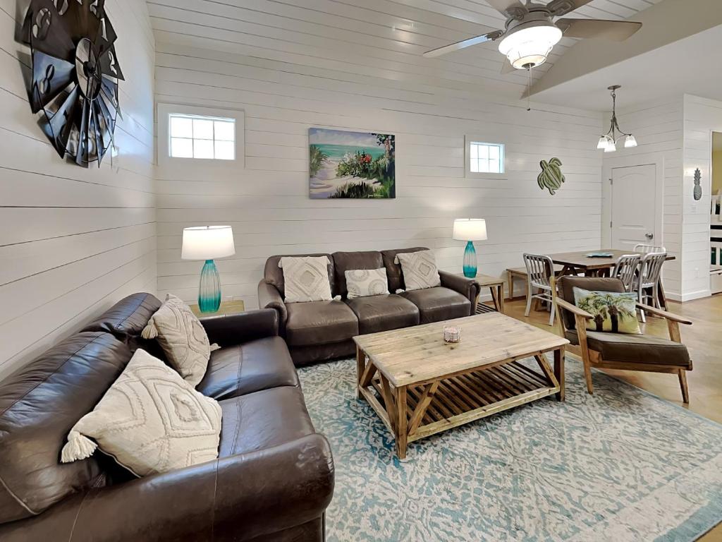 Una sala de estar con un sofá de cuero y una mesa. en Dock Holiday, en Port Aransas