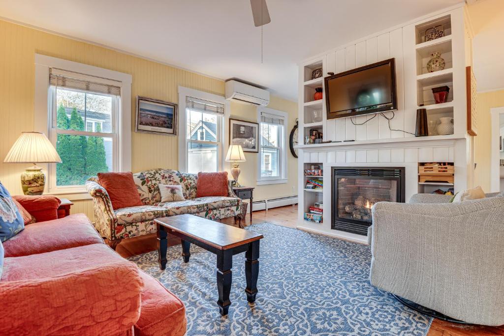 a living room with a fireplace and a tv at Kennebunk Cottage with Yard Less Than 1 Mi to Beach! in Kennebunk