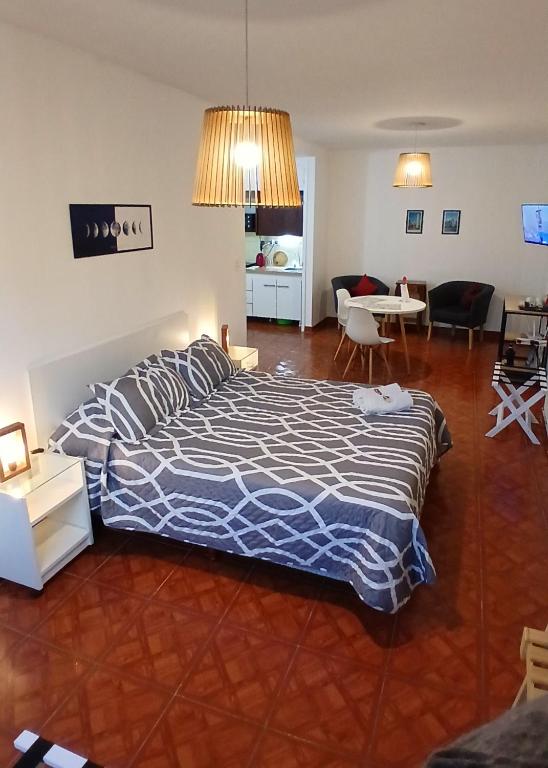 a bedroom with a bed and a living room at FL Depto in Buenos Aires