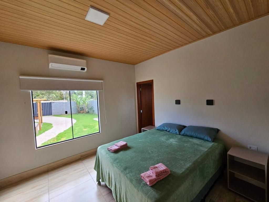 Ένα ή περισσότερα κρεβάτια σε δωμάτιο στο Casa Temporada Bom Clima!