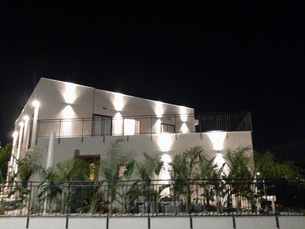 a white building with lights on it at night at וילה מעגל השמש in Poriyya Illit