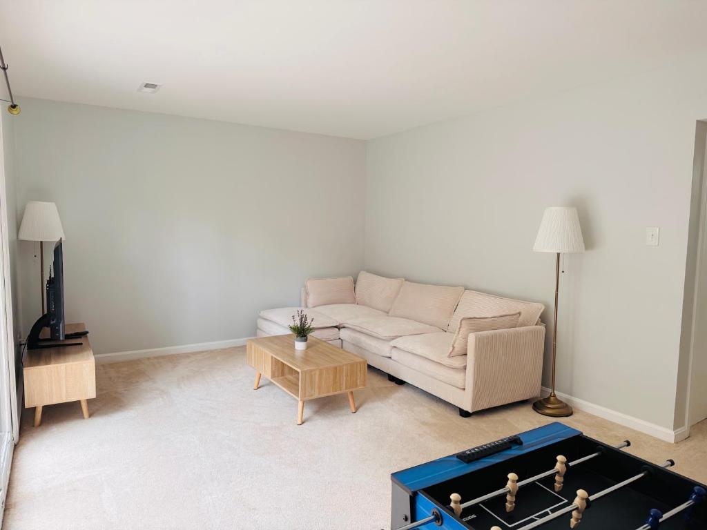 a living room with a couch and a foos ball at Charming 4BR 4BA Townhouse In Annandale, VA in Annandale