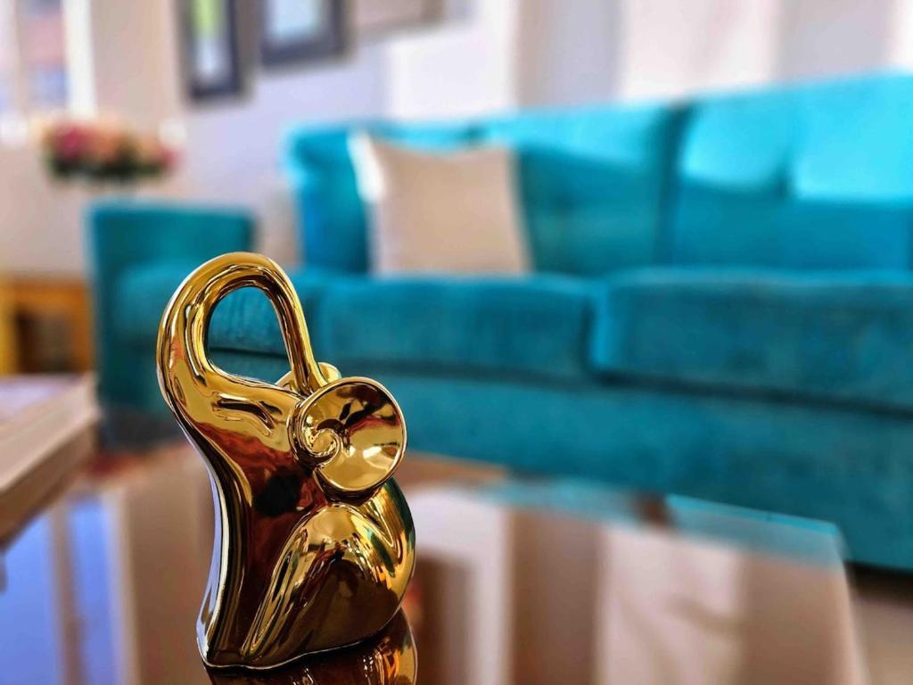 a gold trophy sitting on a table in front of a couch at Luxury Triplex Penthouse with Balcony and Stunning Mountain Views in Bogotá
