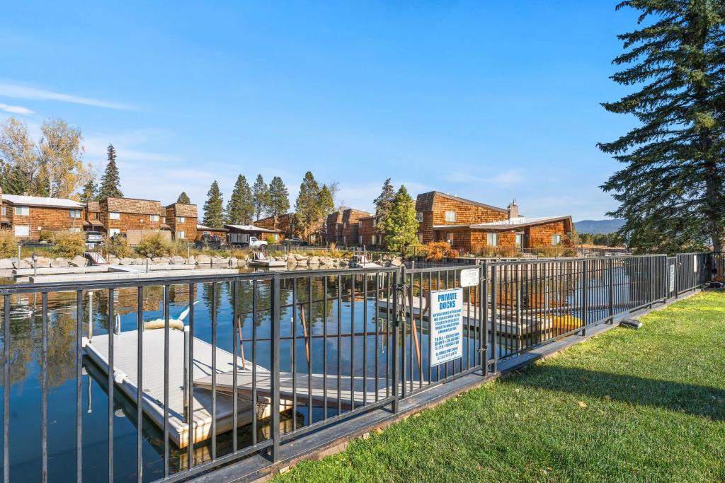 a metal fence with a boat in a marina at TKC0693- Keys Dream townhouse in South Lake Tahoe