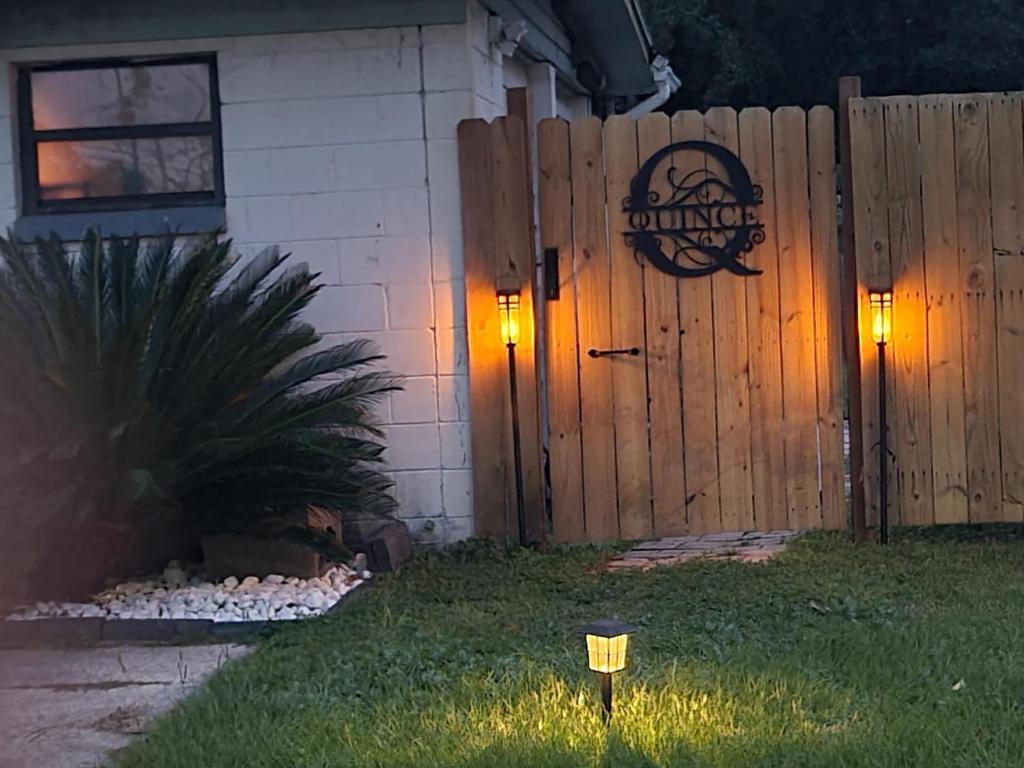 een huis met een hek en verlichting in de tuin bij Twin Pines Studios in Jacksonville