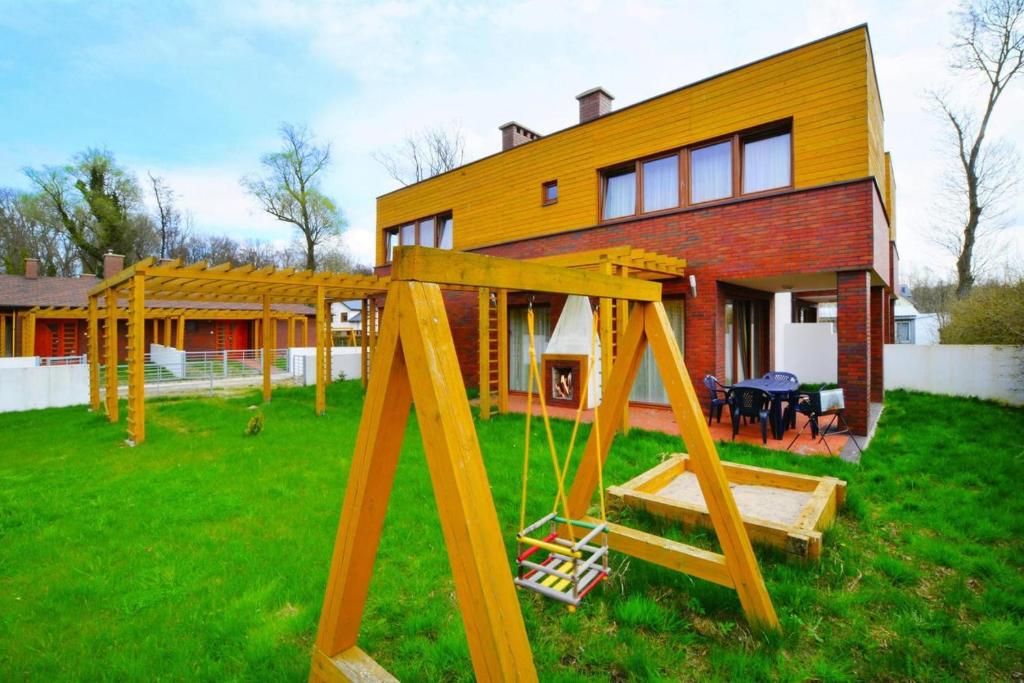 einen Spielplatz im Hof eines Hauses in der Unterkunft Holiday home with a private garden in Sarbinowo