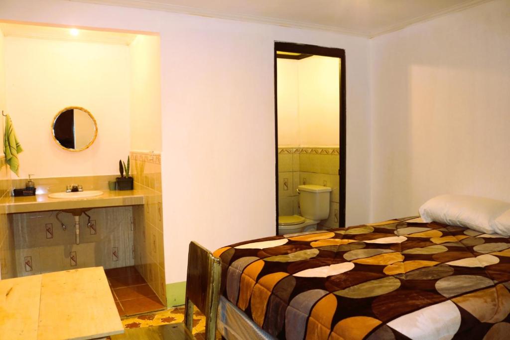 Ένα ή περισσότερα κρεβάτια σε δωμάτιο στο Casa del Barrio Xela