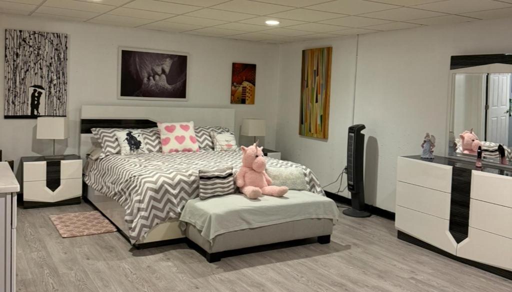 a bedroom with a bed and a pink stuffed animal on a chair at Nice and Cozy! in Lincoln