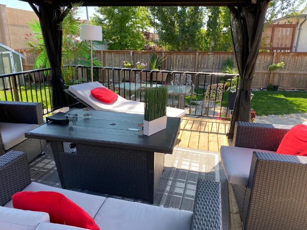 a patio with a table with a dog bed on it at Gull lake in Winnipeg