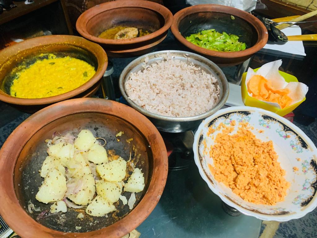 a bunch of bowls of food on a table at Gam Maduwa , cooking class and Tours in Nuwara Eliya