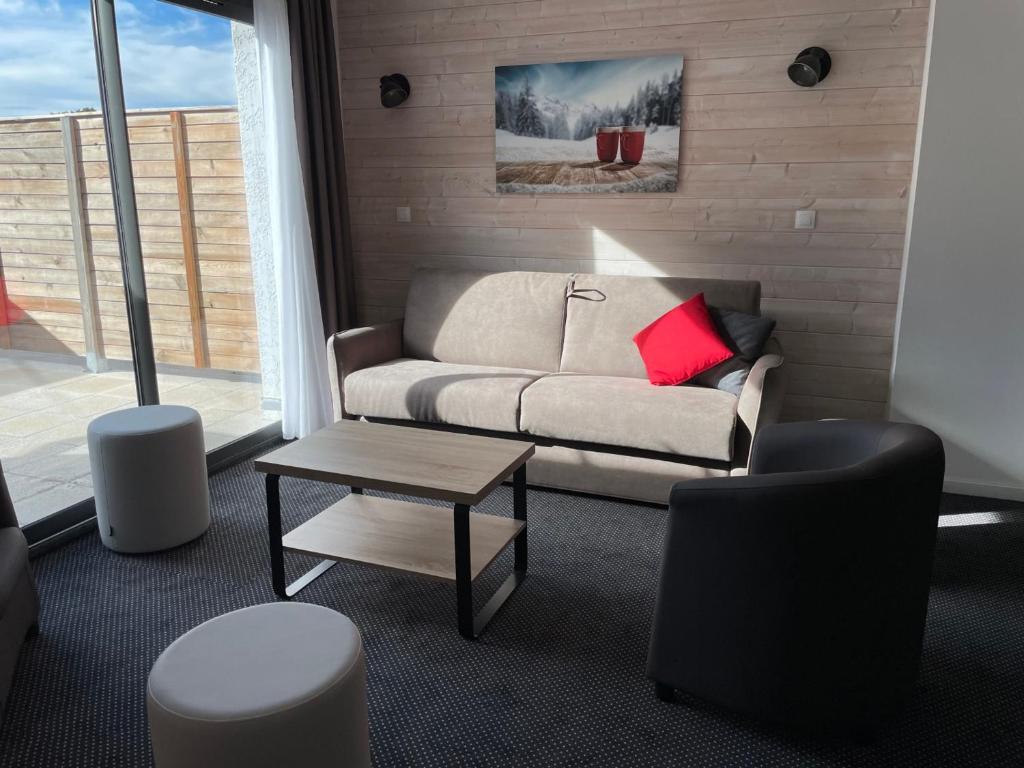 a living room with a couch and a table at Appartement 8 pers, 2 pièces, piscine, animaux admis, Gourette - FR-1-860-23 in Gourette