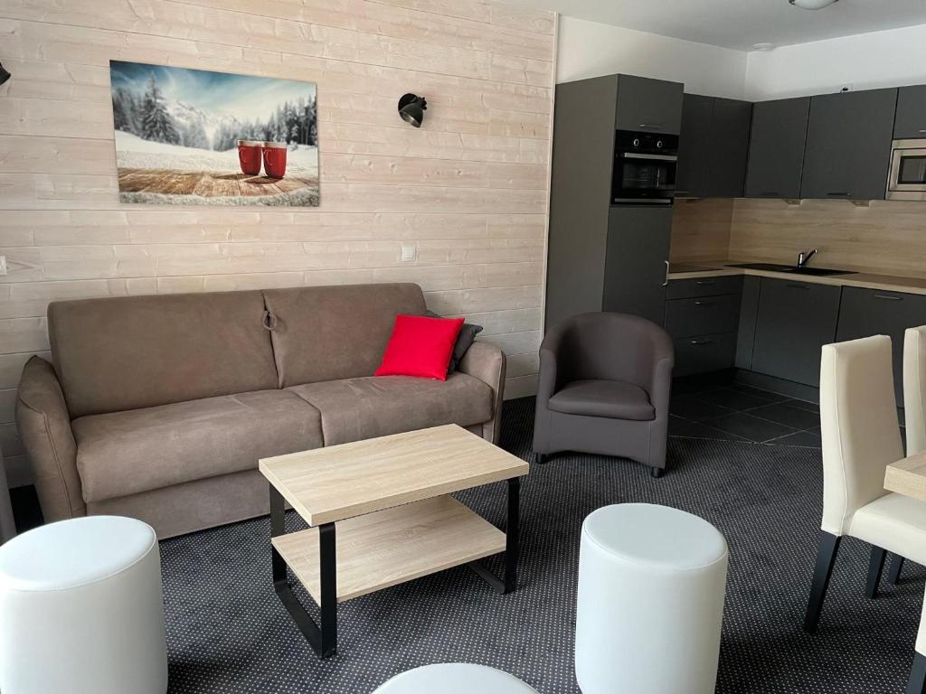 a living room with a couch and a table at Studio cabine 7 pers, piscine, animaux admis, Gourette - FR-1-860-22 in Gourette
