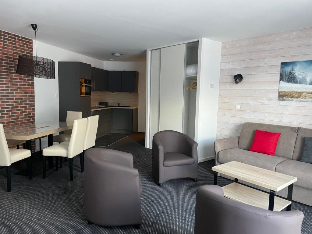 a living room with a couch and a table and chairs at Gourette : Studio 6 pers avec piscine et animaux admis - FR-1-860-25 in Gourette