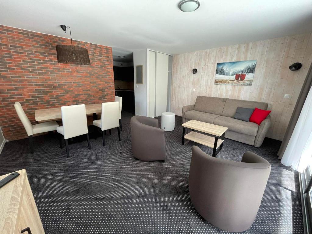 a living room with a couch and a table and chairs at Appartement à Gourette - 6 pers, Piscine, Animaux admis - FR-1-860-27 in Gourette