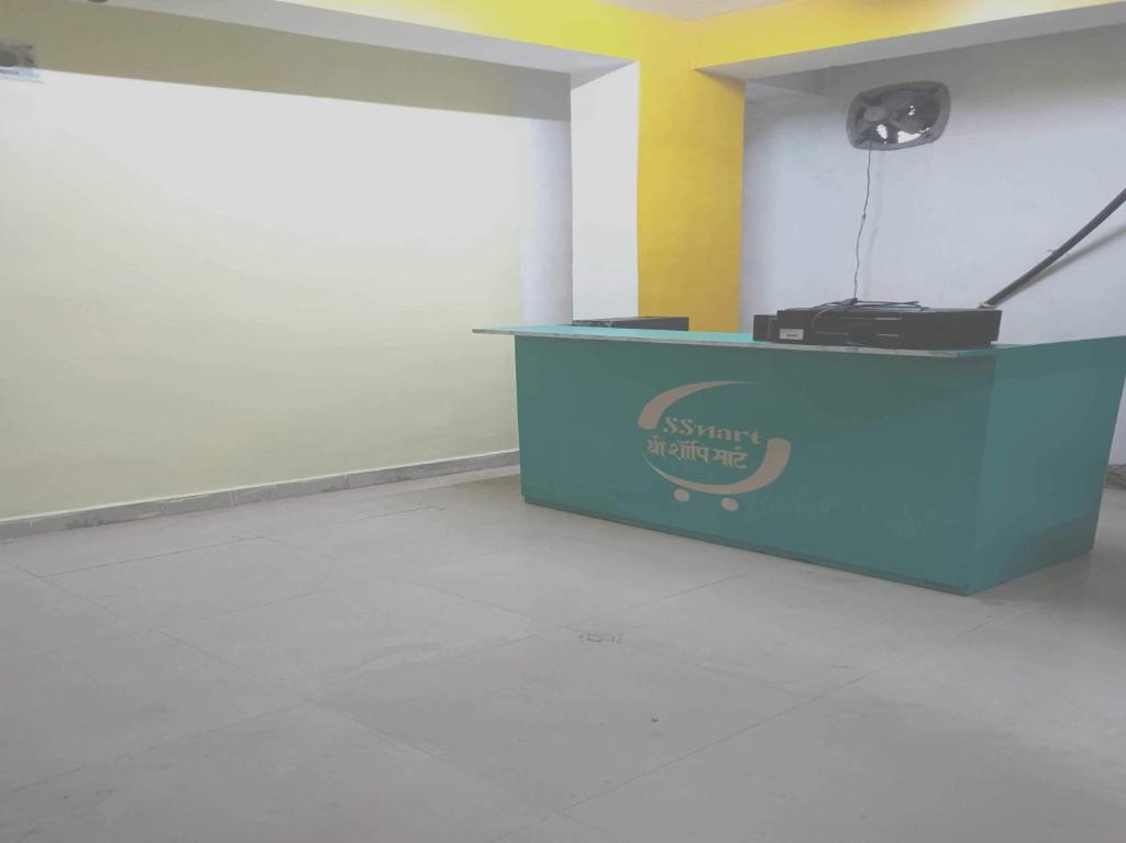 a blue counter with a sign on it in a room at Hotel O Shree hotels in Bhāgalpur