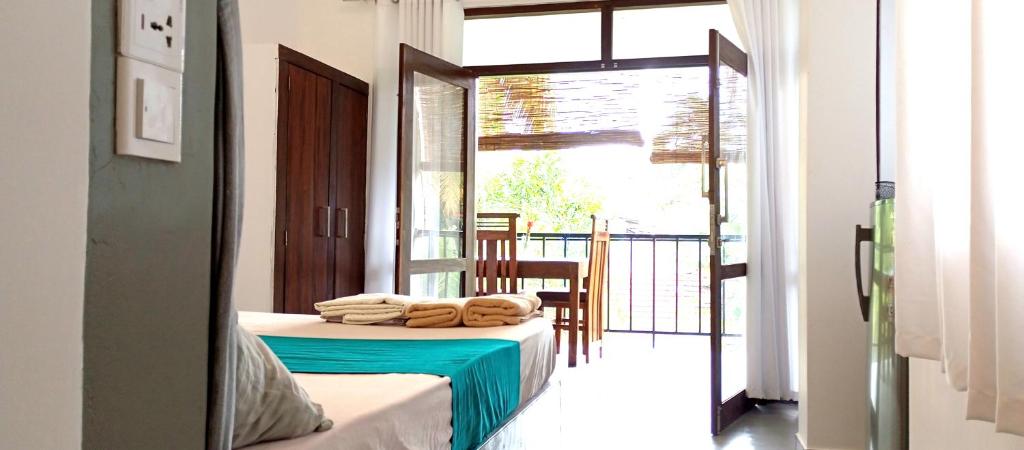 a room with a bed with towels on it at MN House in Unawatuna