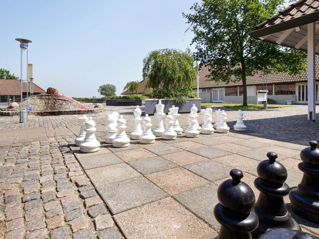 a giant chessboard on a stone patio at Holiday home on a holiday park in Karrebæksminde in Karrebæksminde