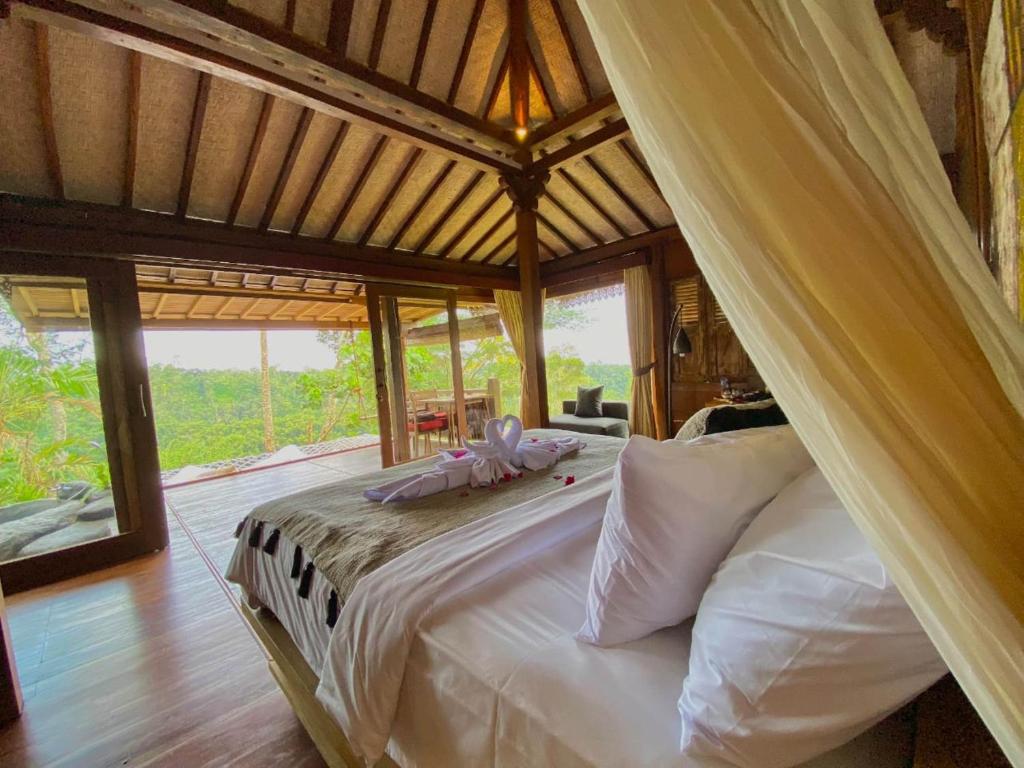 a bedroom with a large bed in a tent at Sunia Jungle Ubud View by EPS in Ubud