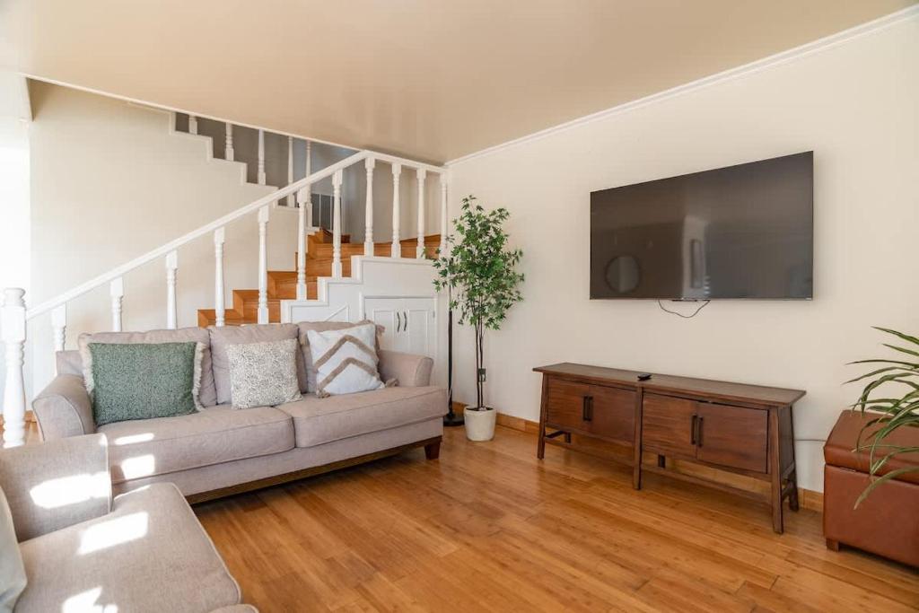 a living room with a couch and a flat screen tv at Beautiful Home at Ensenada 3BR at DT BBQ GRILL in Ensenada