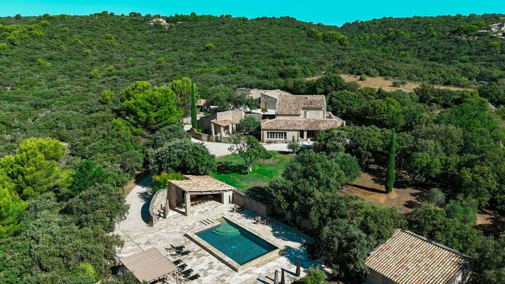 an aerial view of a house with a swimming pool at Stunning Stone House With Pool Near Gordes in Gordes