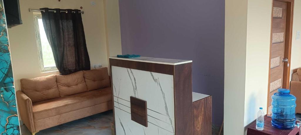 a living room with a couch and a table at Hotel O Laxmi Grand in Dhundgol