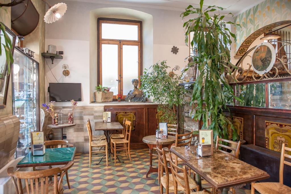 Albergo Vittoria في بوسالا: مطعم بطاولات وكراسي ونافذة