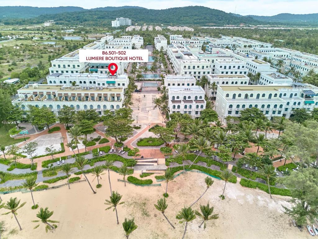 an aerial view of a large white building with a park at Lumiere Boutique Phu Quoc Hotel in Phu Quoc