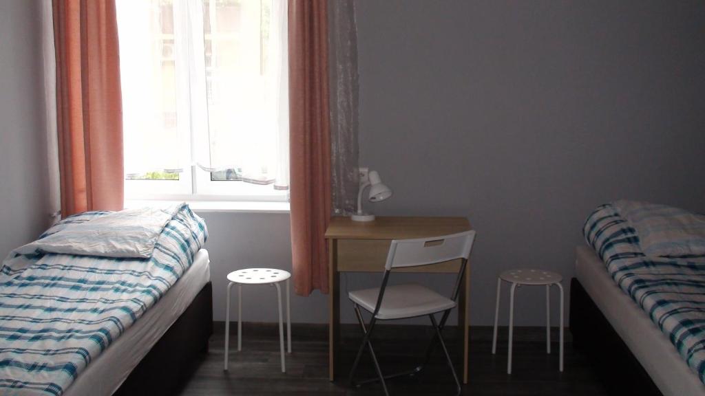 Posteľ alebo postele v izbe v ubytovaní Hostel Kamienna Centrum