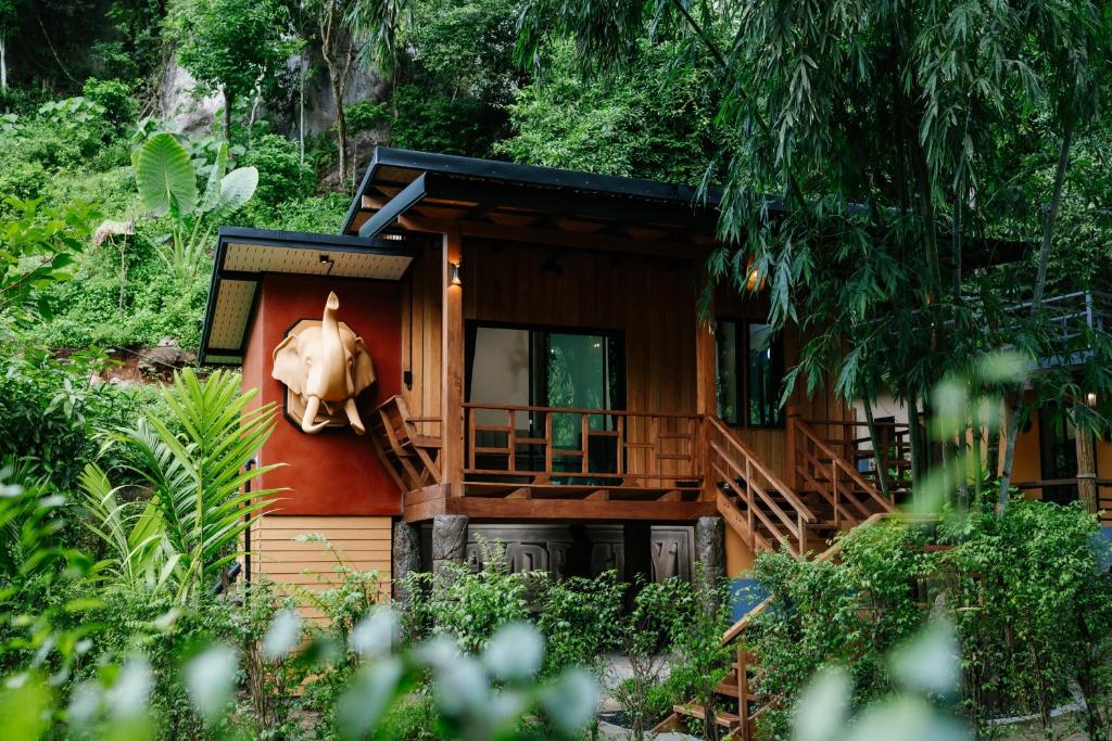 a house with a horse hanging on the side of it at Laydaman Art Homestay in Ao Luk