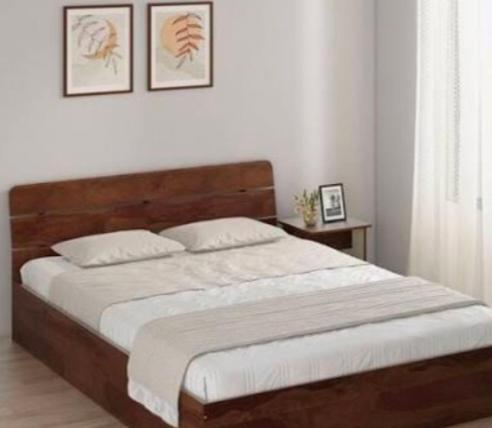 Ένα ή περισσότερα κρεβάτια σε δωμάτιο στο Ambika Residency