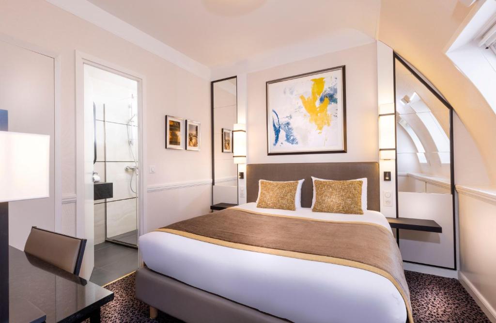a bedroom with a large bed in a room at Elysées Union in Paris