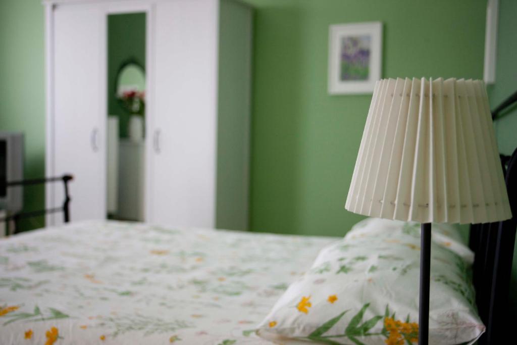 a lamp sitting next to a bed with a pillow at La Casa di Nonna Concettina in Modica