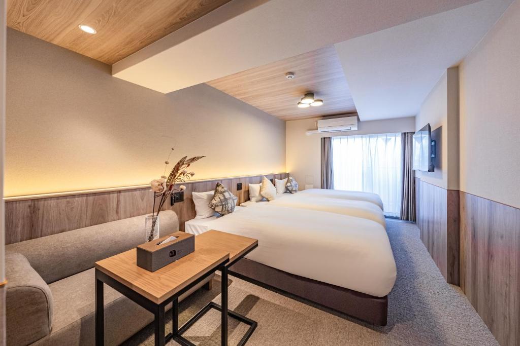 Ένα ή περισσότερα κρεβάτια σε δωμάτιο στο Apartment Hotel 11 Shinimamiya 1