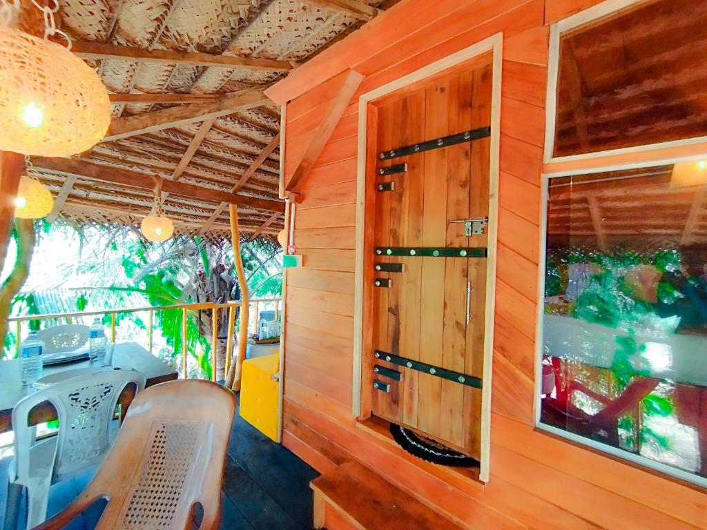 a dining room with a table and a window at Sigiriya Eco Villa in Sigiriya
