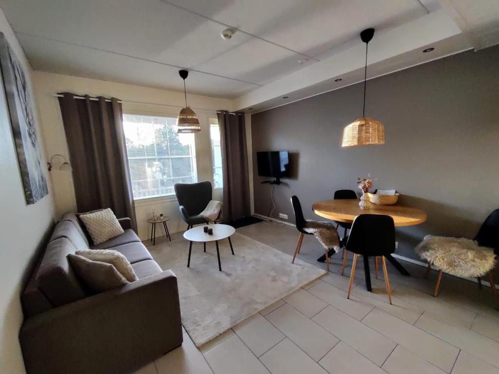 a living room with a couch and a table at Levi Nordic Light in Levi