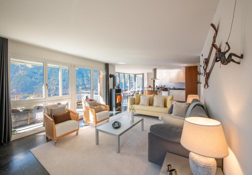 a living room with a couch and chairs at Chalet Silence in Wengen