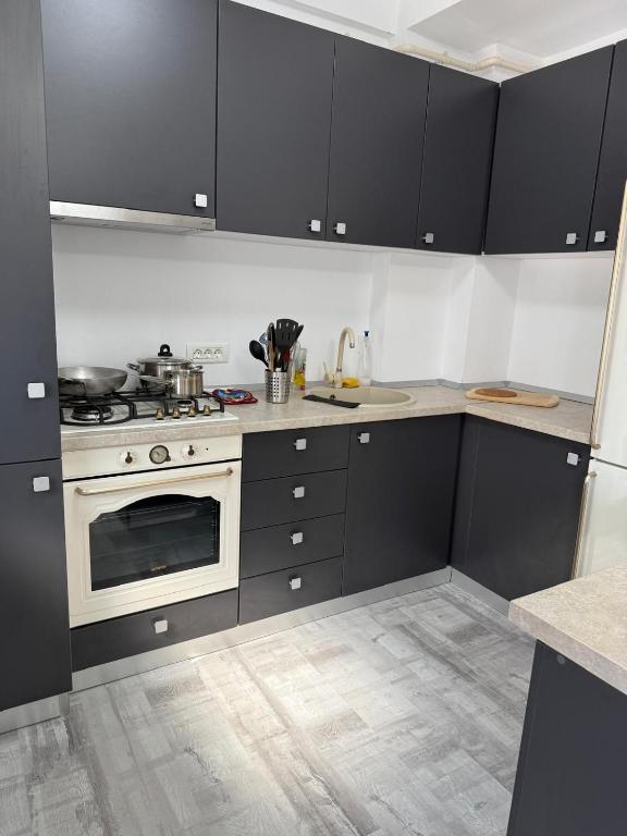 a kitchen with black cabinets and a white oven at La Lumina in Lumina