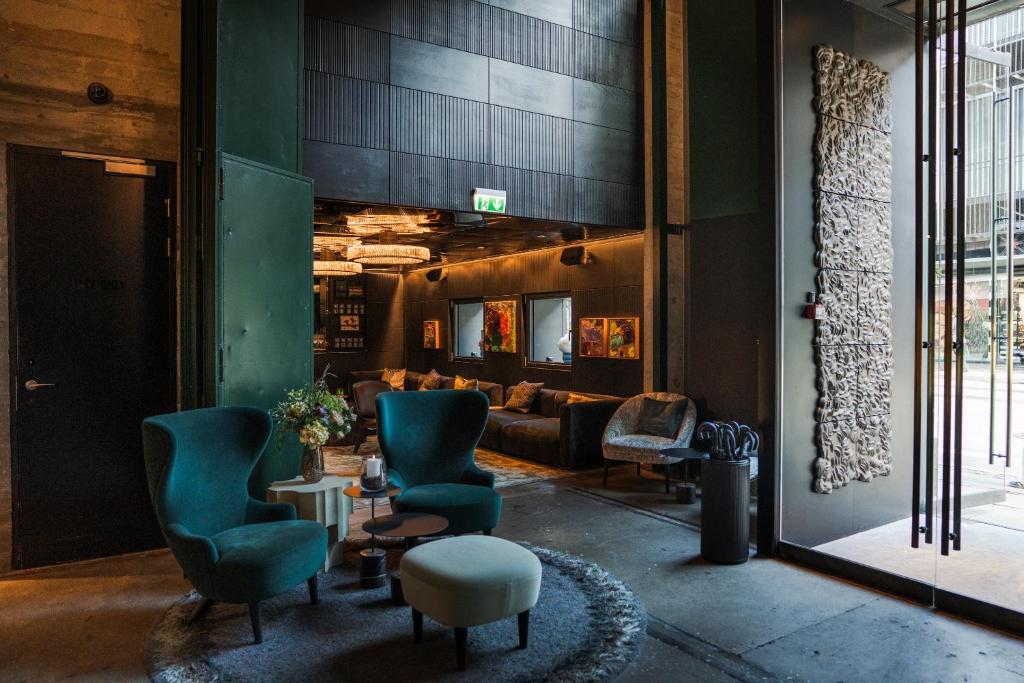 a lobby with chairs and a couch in a room at Boutique Hotel Herman K in Copenhagen