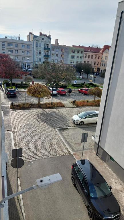 a car parked in a parking lot next to a building at MagMar Studio rynek Kluczbork in Kluczbork