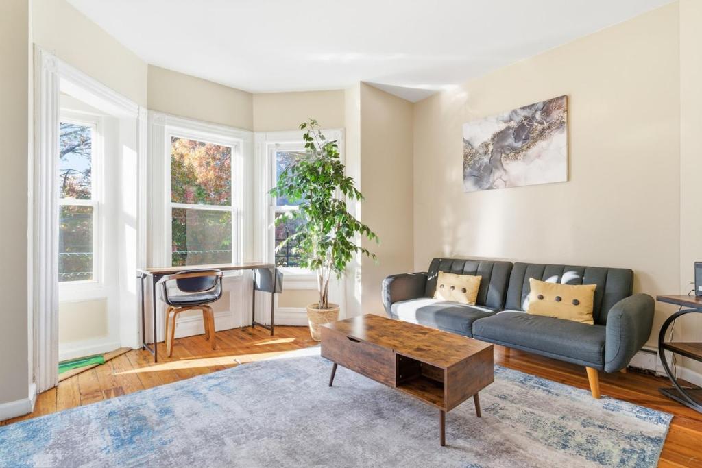 a living room with a couch and a table at Chic 2BR Apartment Near Branch Brook Park in Newark