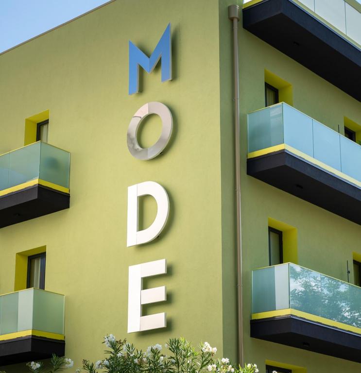 a sign on the side of a building at Mode Eco Mood Hotel in Rimini
