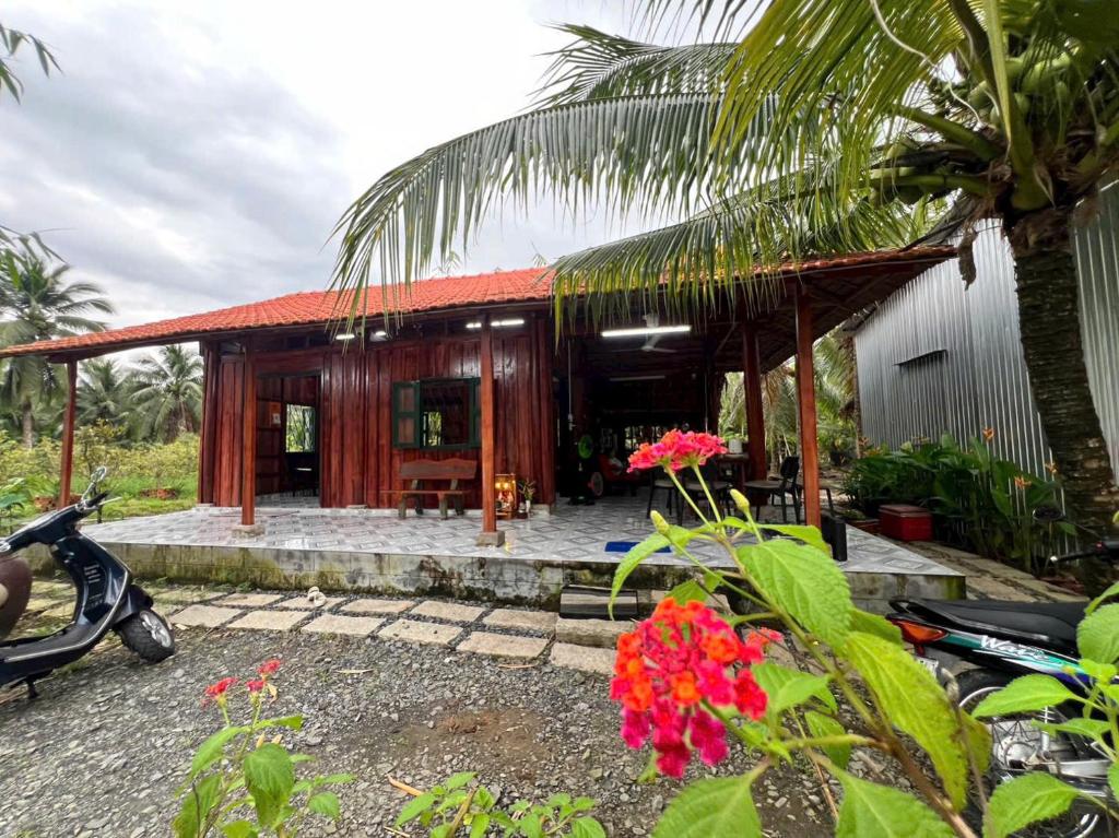 a house with a scooter parked in front of it at Nai Garden in Trung An