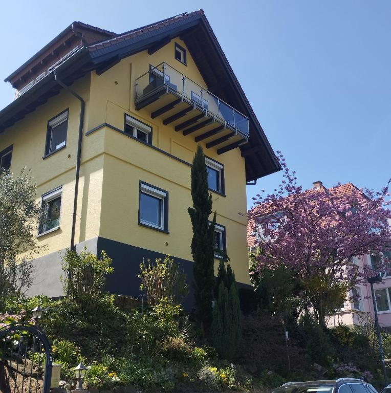 a yellow building with a balcony on it at Nichtraucherferienwohnung-Neckarblick ZE-2022-74-WZ-118A in Heidelberg