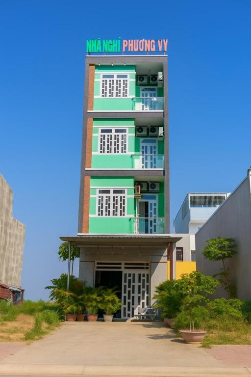 a tall building with a sign on top of it at Phương Vy Motel in Phước Bình