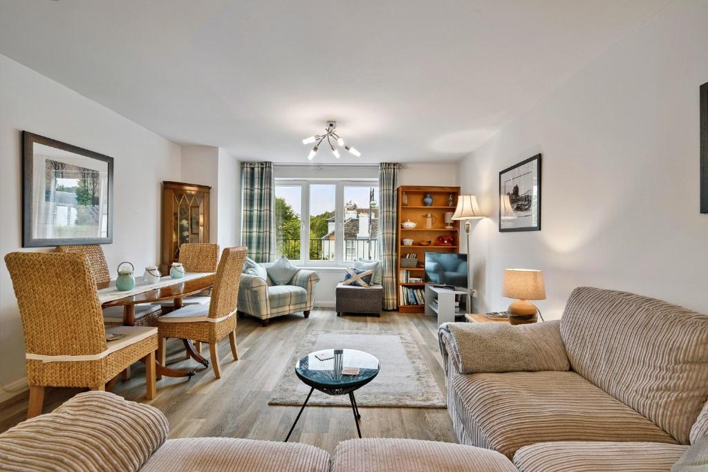 a living room with a couch and a table at Finest Retreats - Riverside View in Balloch