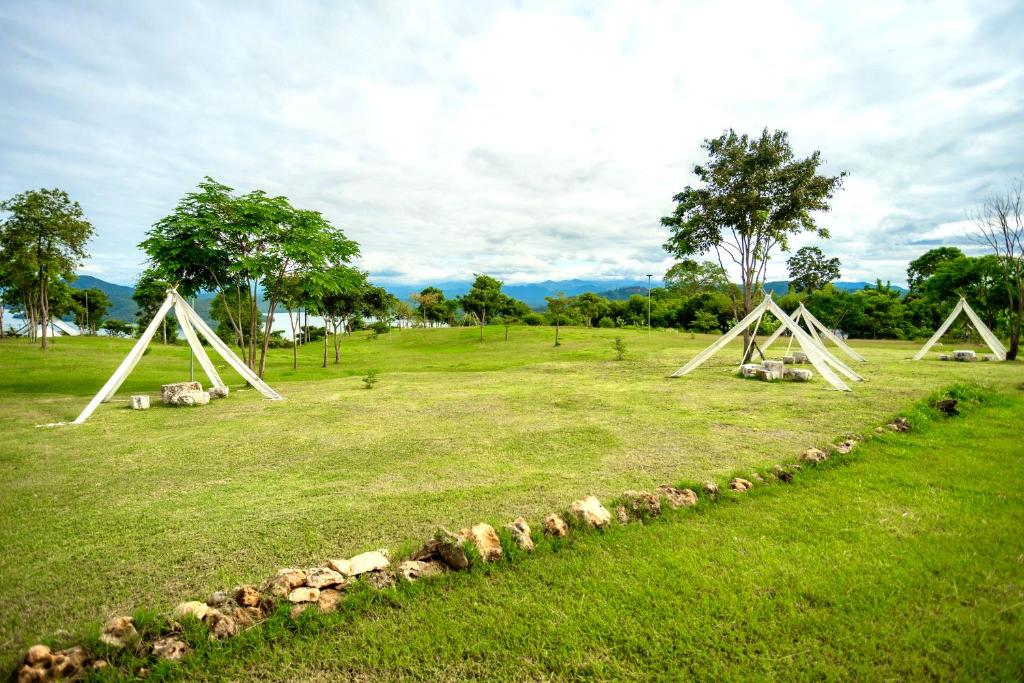 a group of triangular structures in a field at The Hilltop Erawan in Si Sawat